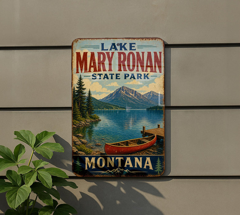 A vintage-style metal sign for Lake Mary Ronan State Park in Montana, featuring a scenic image of a lake, mountains, and a red canoe.