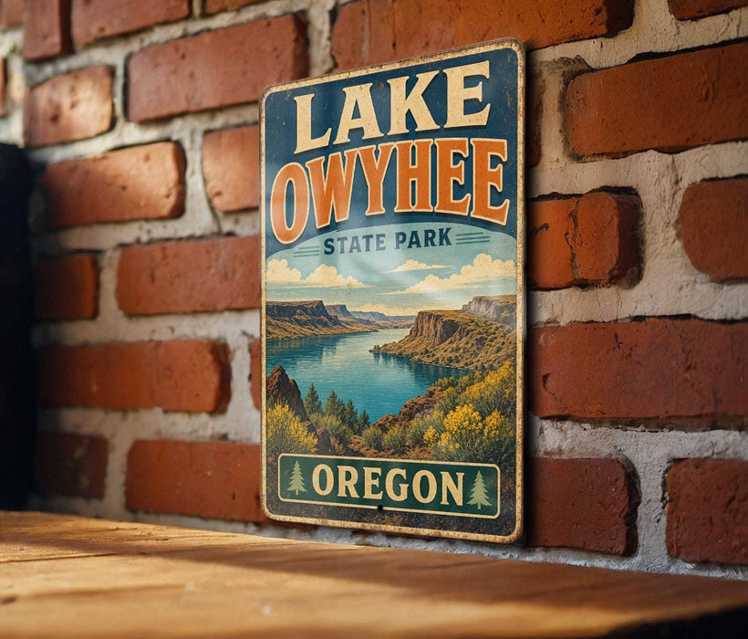 A vintage-style sign for Lake Owyhee State Park in Oregon, featuring a scenic landscape with mountains, a lake, and lush vegetation.