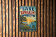 A vintage-style metal sign for Lake Tawakoni State Park in Texas, featuring a scenic illustration of a lake, trees, and a sailboat.
