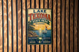 A vintage-style metal sign for Lake Texoma State Park in Oklahoma, featuring a sailboat on a lake and a sunset in the background.