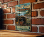 A vintage-style metal sign for Lake Vermilion-Soudan Underground Mine, located in Minnesota, with a scenic illustration of a tunnel and a lantern.