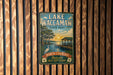 A vintage-style metal sign for Lake Waccamaw State Park, featuring a scenic illustration of the park's natural surroundings.