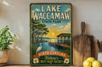 A vintage-style sign for Lake Waccamaw State Park, featuring a scenic illustration of a lake, dock, and sunset.