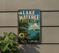 A vintage-style sign for Lake Wateree State Park in South Carolina, featuring a scenic landscape with a lake, trees, and a sailboat.