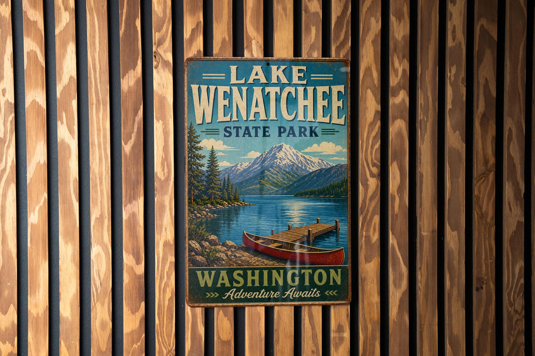 A vintage-style metal sign for Lake Wenatchee State Park, featuring a scenic image of a lake, mountains, and a canoe.
