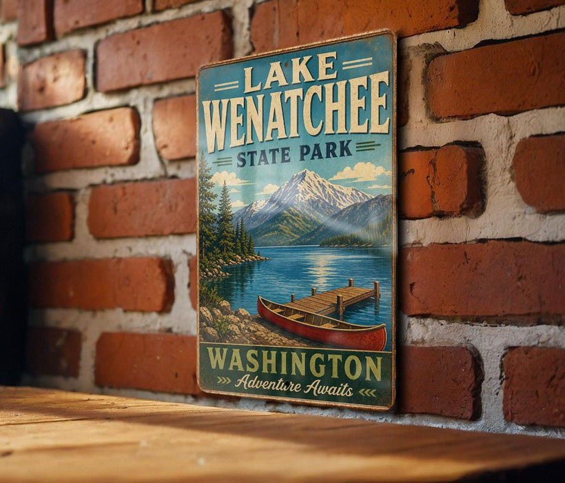 A vintage-style metal sign for Lake Wenatchee State Park, featuring a scenic illustration of a lake, mountains, and a canoe.