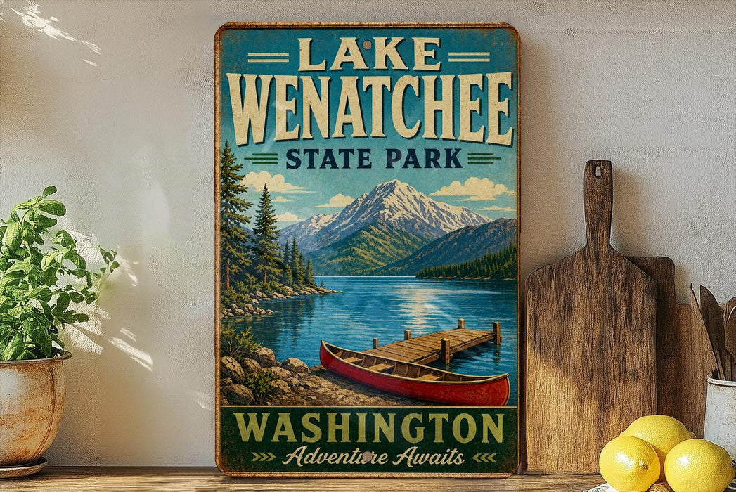 A vintage-style sign for Lake Wenatchee State Park in Washington, featuring a scenic image of a lake, mountains, and a red canoe.