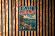 A vintage-style metal sign for Lake Whitney State Park in Texas, featuring a scenic landscape with a lake, mountains, and a sailboat.