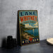 A vintage-style sign for Lake Whitney State Park, featuring a scenic landscape with a lake, mountains, and a sailboat.