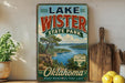 A vintage-style sign for Lake Wister State Park in Oklahoma, featuring a scenic landscape with a lake and mountains.