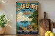 A vintage-style sign for Lakeport State Park in Michigan, featuring a scenic illustration of a lake, dock, and surrounding nature.