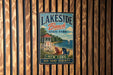 A vintage metal sign for Lakeside Beach State Park, featuring a lifeguard tower, beach chairs, and a scenic view of the ocean.