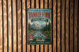 A vintage-style metal sign for the Land of the Yankee Fork State Park in Idaho, featuring a scenic mountain landscape and a river.