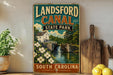 A vintage-style sign for Landsford Canal State Park in South Carolina, featuring a scenic illustration of a canal, bridge, and surrounding landscape.