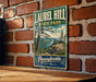 A vintage-style metal sign for Laurel Hill State Park in Pennsylvania, featuring a scenic landscape with a river and pine trees.