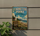 A vintage-style sign for Leadbetter Point State Park in Washington, featuring a lighthouse and a beach scene.