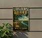 A vintage-style metal sign for Leffeur's Bluff State Park in Mississippi, featuring a scenic landscape with a river and cliffs.