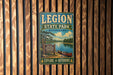 A vintage-style metal sign for Legion State Park in Mississippi, featuring a scenic landscape with a lake, trees, and a canoe.