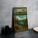 A vintage-style metal sign for the Leominster State Forest in Massachusetts, featuring a scenic landscape with pine trees, a lake, and mountains.