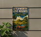 A vintage-style sign for Lechworth-Love Mounds, an archaeological state park in Florida, featuring a scenic landscape with palm trees and hills.