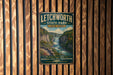 A vintage metal sign for Litchworth State Park in New York, featuring a scenic image of a waterfall and forested mountains.