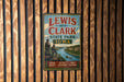 A vintage metal sign for Lewis and Clark State Park in Iowa, featuring a scenic illustration of the park and its surroundings.