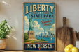 A vintage-style sign advertising Liberty State Park in New Jersey, featuring the Statue of Liberty and the New Jersey skyline.