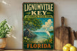 A vintage-style sign for Lignum Vitae Key, a botanical state park in Florida, featuring a seagull and a tropical landscape with a tree and water.