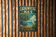 A vintage-style metal sign for Lignum vitae Key, a botanical state park in Florida, featuring a seagull and a tropical landscape.