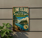 A vintage-style metal sign for the Lime Island State Recreation Area in Michigan, featuring a scenic landscape with pine trees, a lake, and mountains.