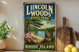 A vintage-style sign for Lincoln Woods State Park in Rhode Island, featuring a scenic landscape with a lake, pine trees, and a beach.