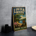 A vintage-style metal sign for Lincoln Woods State Park, featuring a scenic landscape with a lake, pine trees, and a sign indicating the location.