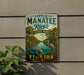 A vintage-style metal sign for Little Manatee River State Park in Florida, featuring a scenic illustration of the river, palm trees, and a heron.