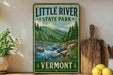 A vintage-style sign for Little River State Park in Vermont, featuring a scenic illustration of a river surrounded by mountains and pine trees.
