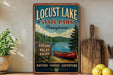 A vintage-style sign for Locust Lake State Park in Pennsylvania, featuring a canoe and a scenic landscape.