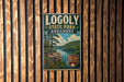 A vintage metal sign for Logoly State Park in Arkansas, featuring a scenic landscape with a river and forest.