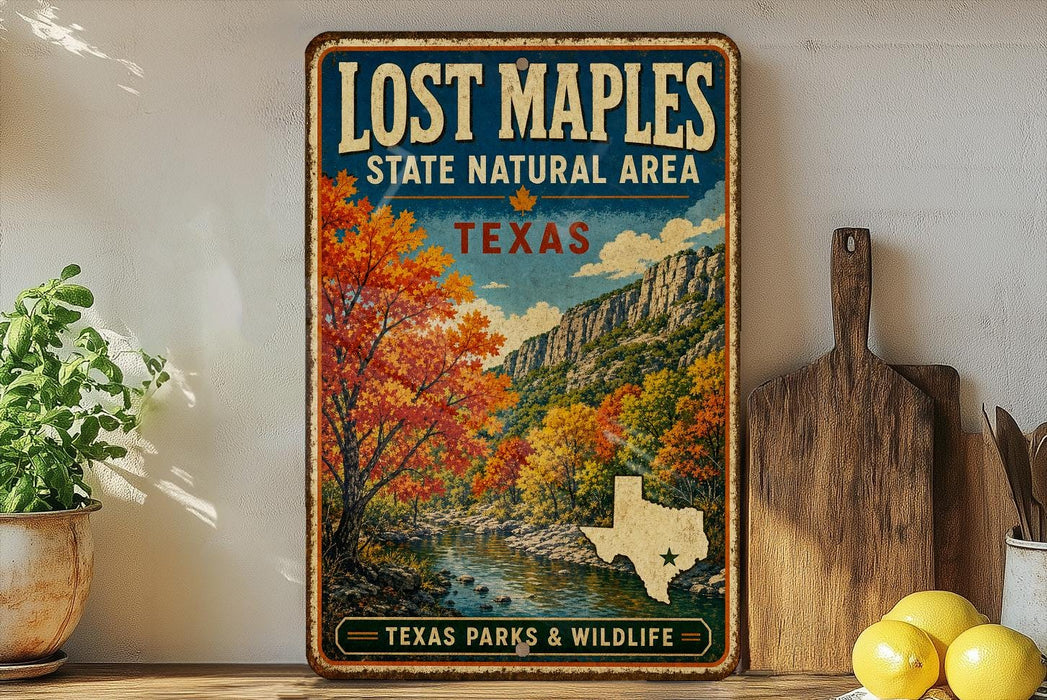A vintage-style metal sign for Lost Maple State Natural Area in Texas, featuring a scenic landscape with a river and autumn foliage.