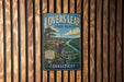 A vintage metal sign for "Lovers Leap State Park" hanging on a wooden wall.
