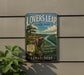 A vintage-style metal sign for "Lovers Leap State Park" in Connecticut, featuring a scenic landscape with a river and cliffs.