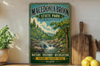 A vintage-style sign for Macerania Brook State Park in Connecticut, featuring a scenic illustration of a waterfall and forest.