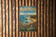 A vintage metal sign for Macker richer State Park in California, featuring a scenic coastal landscape with rocky cliffs, ocean waves, and a beach.