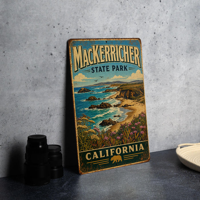 A vintage-style metal sign for Mackerriner State Park in California, featuring a scenic coastal landscape with rocky cliffs, ocean waves, and a California state bear.