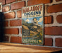 A vintage metal sign for Malakoff Diggin's State Historic Park in California, featuring an illustration of a mining operation on a hillside.