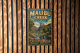 A vintage-style metal sign for Malibu Creek State Park in California, featuring a scenic mountain landscape.