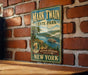 A vintage-style metal sign for Mark Twain State Park in New York, featuring a scenic illustration of a river and a steamboat.