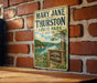 A vintage metal sign for Mary Jane Thurston State Park in Ohio, featuring a scenic landscape with a lake and trees.