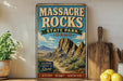 A vintage-style sign for Massacre Rocks State Park in Idaho, featuring a scenic mountain landscape.