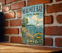 A vintage-style metal sign for Mauhee Bay State Park in Ohio, featuring a scenic illustration of a sailboat on the water and a bird on the shore.
