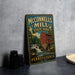 A vintage metal sign for McConnells Mill State Park in Pennsylvania, featuring a red brick building and a waterfall.