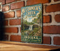 A vintage-style metal sign for McCormick's Creek State Park in Indiana, featuring a scenic illustration of a waterfall surrounded by lush greenery.